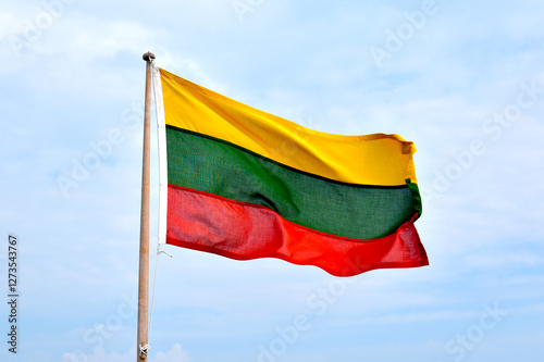 Quadro su tela The flag of Lithuania, on a light background, the wind flies the flag