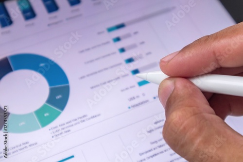 Businessman reviewing a business plan or a business financial data analysis graphic report on digital screen photo