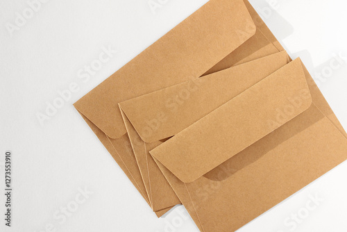 Paper Stationery. Kraft Envelopes Arranged on White Background. Minimal Business Branding Design.