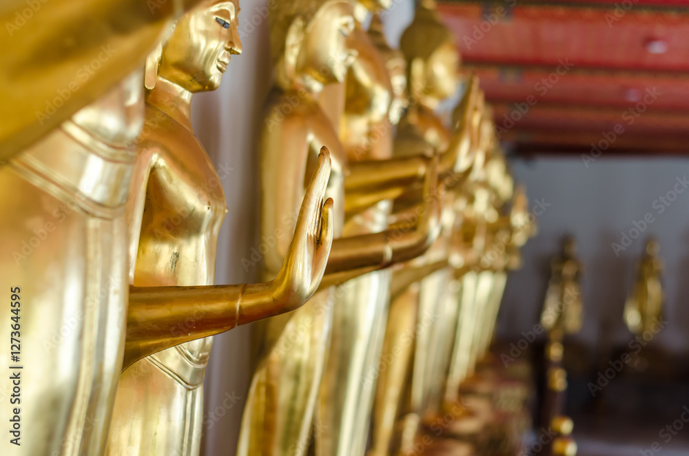 Fototapeta premium Golden Buddha statues in a serene setting
