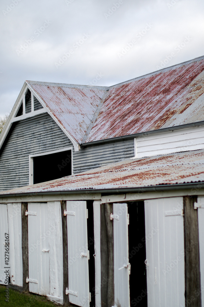 Old weathered work shed with timber doors and corrugated iron roofs Old weathered work shed with timber doors and corrugated iron roofs