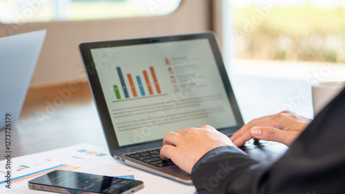 business analytics, financial planning, and digital marketing, a person working on a laptop with a data chart displayed. market analysis, corporate strategy, and productivity in a digital workplace.