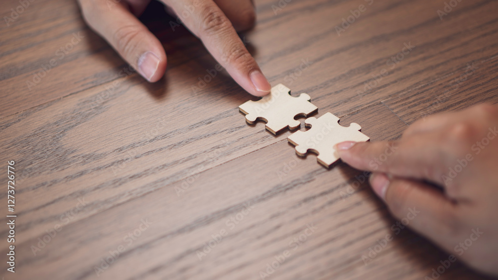teamwork, problem and collaboration, featuring two hands connecting puzzle pieces surface. the idea of partnership, strategy, and finding the right fit in both business and personal relationships.