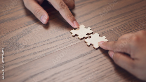 Obraz na płótnie teamwork, problem and collaboration, featuring two hands connecting puzzle pieces surface. the idea of partnership, strategy, and finding the right fit in both business and personal relationships. w salonie