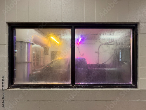 Pickup truck in car wash seen through window photo