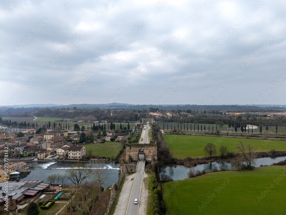 Fototapeta premium Valeggio sul Minicio,a charming village on the river Mincio with ancient fortified bridge and Scaliger Castle