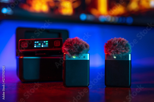 Radio lavalier microphone with receiver and case. Neon background