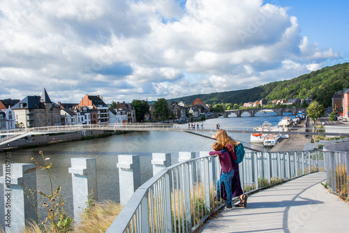 Tourists look at the Meuse River in the city of Namur