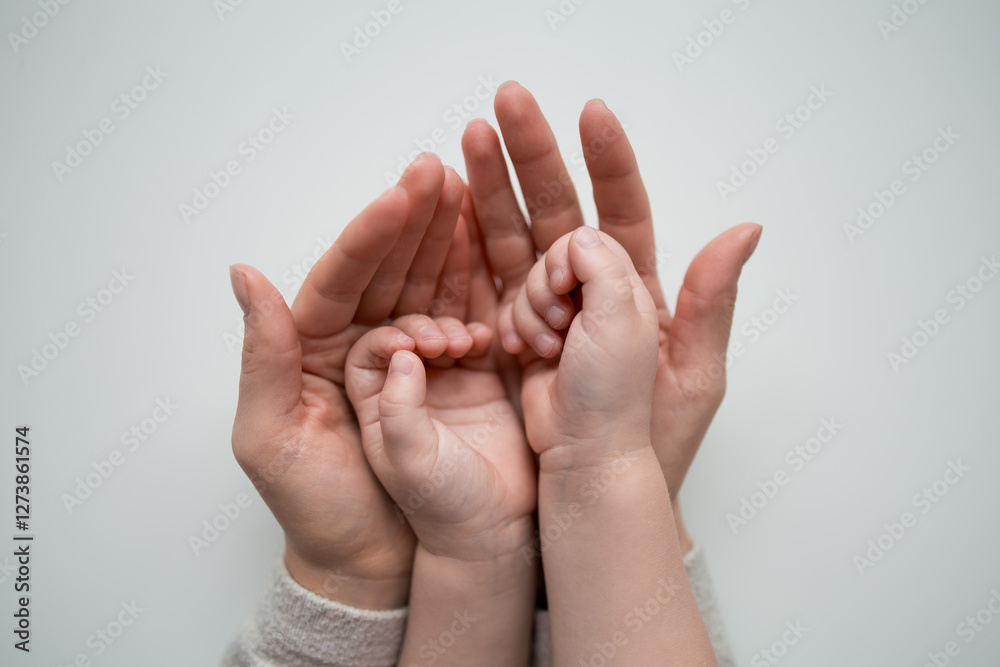 Caucasian adult and child hands together bonding moment in harmony Caucasian adult and child hands together bonding moment in harmony
