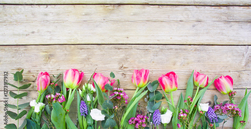 spring flowers on wooden ba...