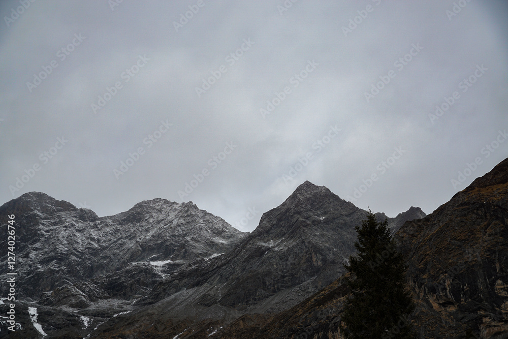 Obraz premium Mountain peaks in overcast sky alpine region nature photography dramatic landscape wide angle adventure exploration