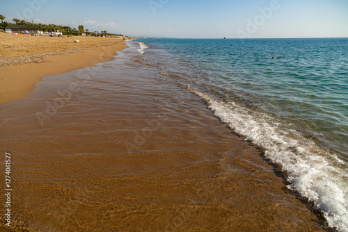 Fototapeta Naklejka Na Ścianę i Meble -  Empty beach on the Mediterranean Sea in low season on a sunny day. Sorgun, Manavgat, Antalya province, Turkey. November