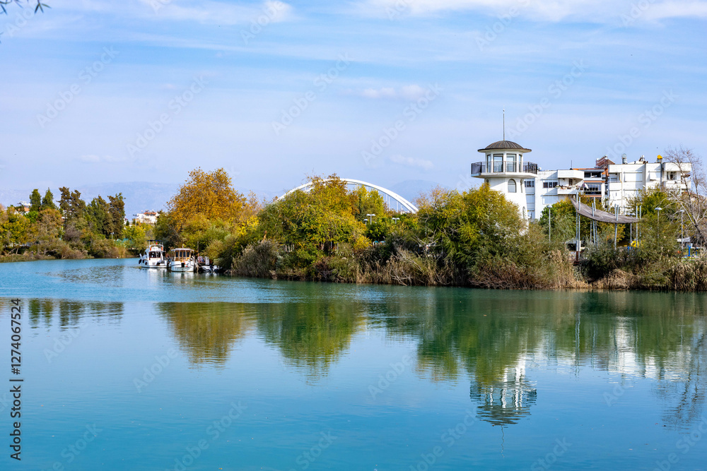 Panorama of the Manavgat River with turquoise water in the city center. Lighthouse on the river bank. Panorama of the Manavgat River with turquoise water in the city center. Lighthouse on the river bank.