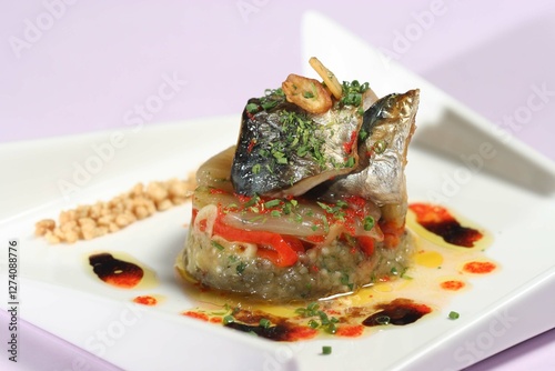 Roasted mackerel fillet resting on vegetable timbale, garnished with crisp croutons, drizzled balsamic vinegar, extra virgin olive oil