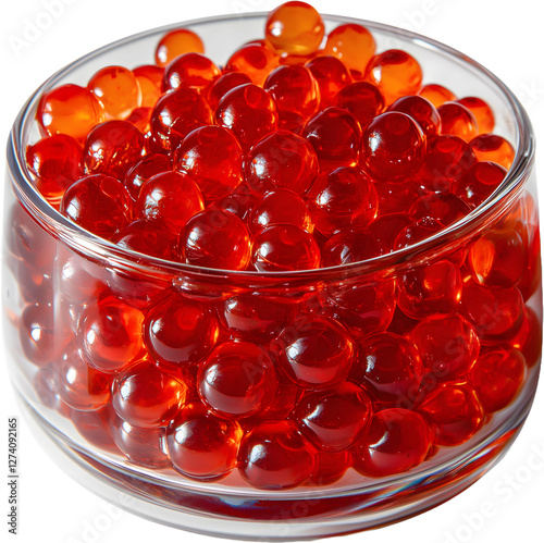 A clear glass is filled with bright red fish egg or popping boba balls.