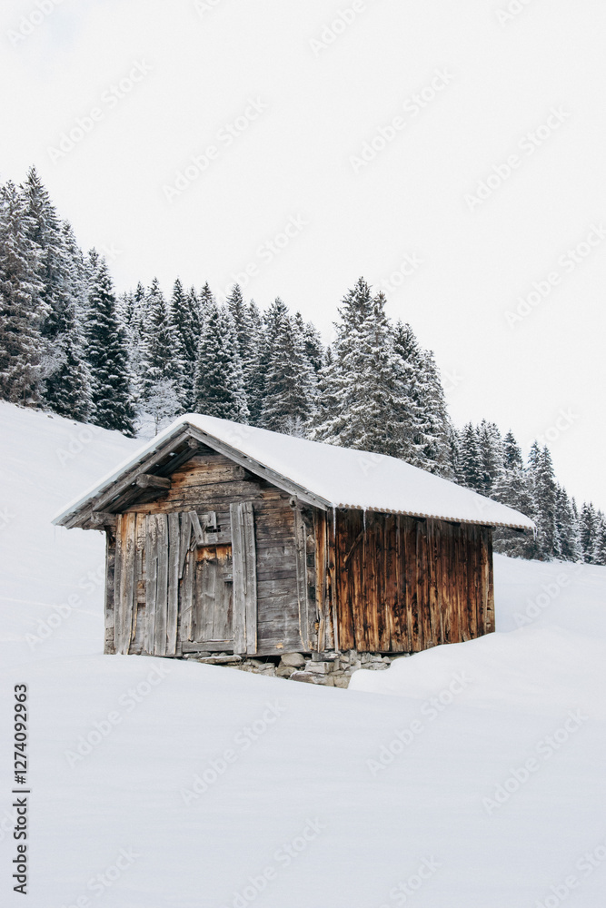 An old cabin in the snow covered mountains of switzerland An old cabin in the snow covered mountains of switzerland
