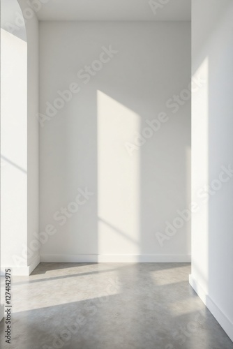 Empty room with arched window and sunlight illuminating the floor and walls