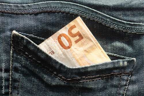 Fifty euro banknote money in pocket jeans pants background texture. 50 euro close up