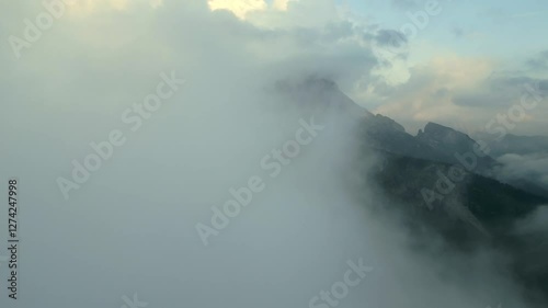 Aerial panoramic view of Dolomites Alps with impressive clouds in Italy