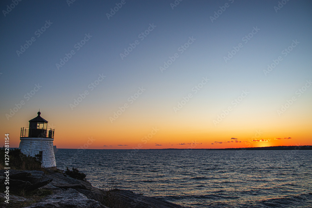 Coastal Lighthouse Overlooking the Ocean at Sunset Coastal Lighthouse Overlooking the Ocean at Sunset
