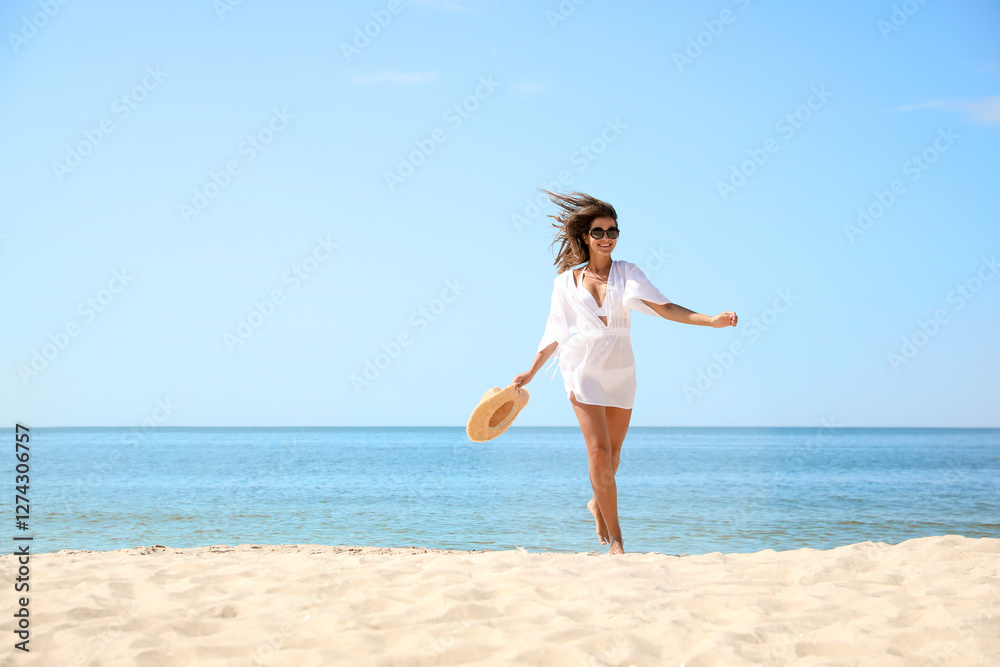 Young woman with beautiful body on sandy beach. Space for text Young woman with beautiful body on sandy beach. Space for text