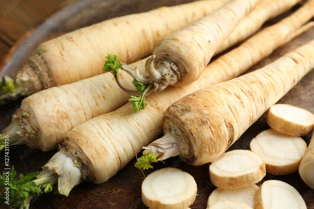 Whole and cut fresh parsley roots on table, closeup Whole and cut fresh parsley roots on table, closeup
