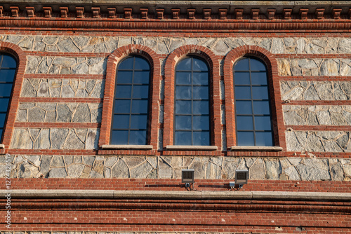 Canvas-taulu detail of the project and recovery of a historic post-industrial building with facade elements of brick and stone, the windows cite modern triple lancet windows with arches and brick frames