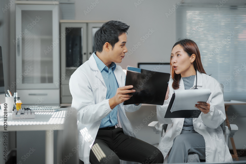Doctors examining radiography during medical consultation in hospital office Doctors examining radiography during medical consultation in hospital office