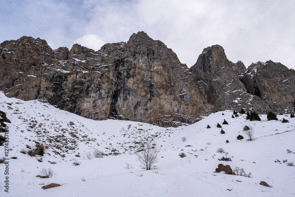 Winter landscape in the mountains not far from Almaty, Maloalmatinskoe gorge in winter. Snow and mountains, popular tourist route. Winter landscape in the mountains not far from Almaty, Maloalmatinskoe gorge in winter. Snow and mountains, popular tourist route.
