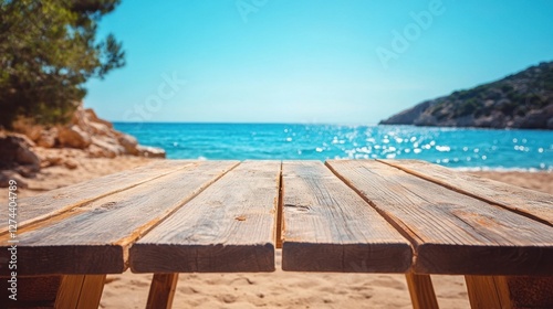 Fototapeta Naklejka Na Ścianę i Meble -  Serene beach picnic table vista offering a tranquil ocean view under a clear sky capturing the essence of summer relaxation and coastal charm