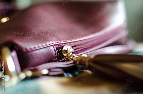 Handbag with a dark pink fabric. Metal zipper and gold hardware