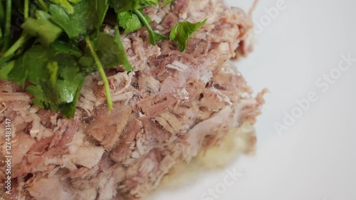 Prepared homemade beef aspic on plate, topping with parsley and dill. High quality 4k footage photo