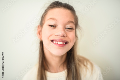Portrait of disabled girl smiling at camera isolated over white background.
