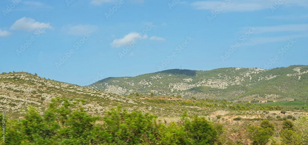 Naklejka premium Scenic Rolling Hills Under Blue Sky