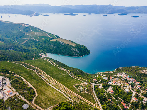 Southern Croatia vineyards and Adriatic coastline near Kremena and Komarna, showcasing scenic rolling hills and lush vineyards photo