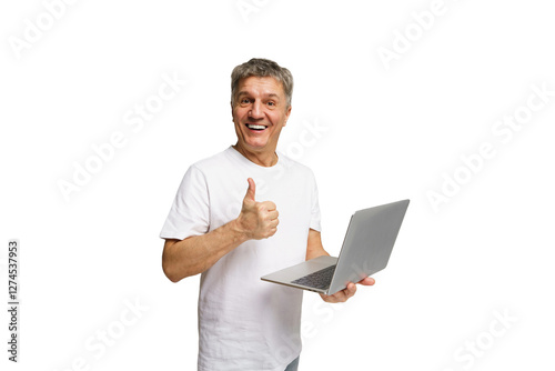 Older man expressing joy while holding a laptop and giving a thumbs up in a bright setting photo