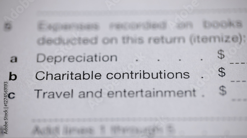 Tax form focusing on expense deductions, including charitable contributions and travel. Itemizing deductions for tax return optimization.