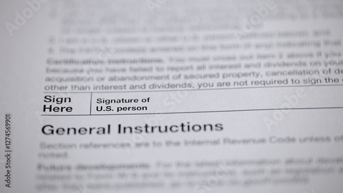 Close-up of a document with instructions and a signature line for a U.S. person, emphasizing legal requirements and personal responsibility. photo