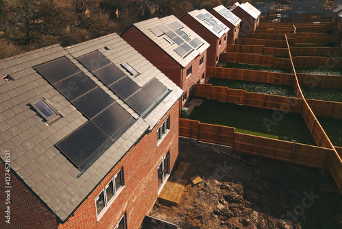 Aerial view of New residential houses fitted with solar panels in a suburban neighborhood during daylight