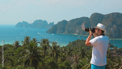 Photographer takes pictures of the beautiful panorama from the top mountain v