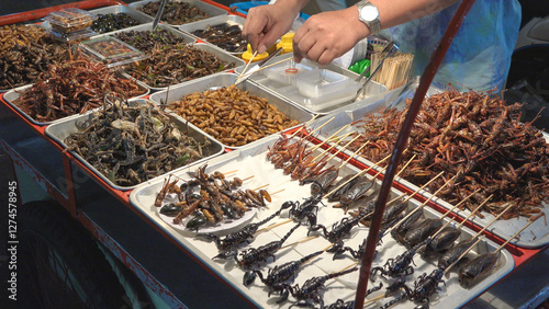 Roasted insects, worms and scorpions as food for sale on street market in Ban