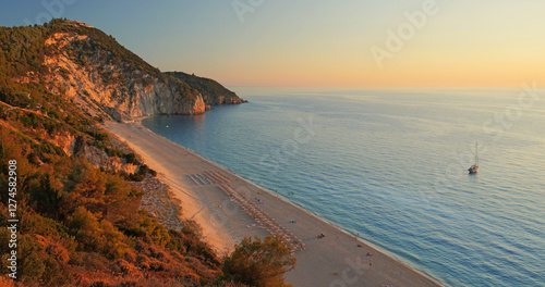 Blue sea and red sunset light on the cliffs of Mylos beach in Lefkada island photo