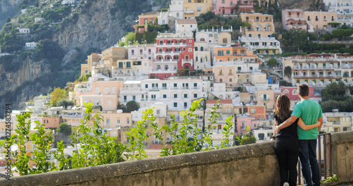 Lovers couple admiring the picturesque panorama Positano on Amalfi coast, Italy