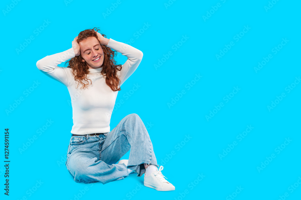 Young woman enjoying moment of relaxation on bright blue background Young woman enjoying moment of relaxation on bright blue background