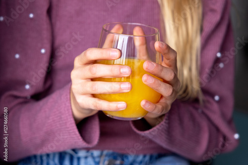 Anonymous little girl with glass of juice