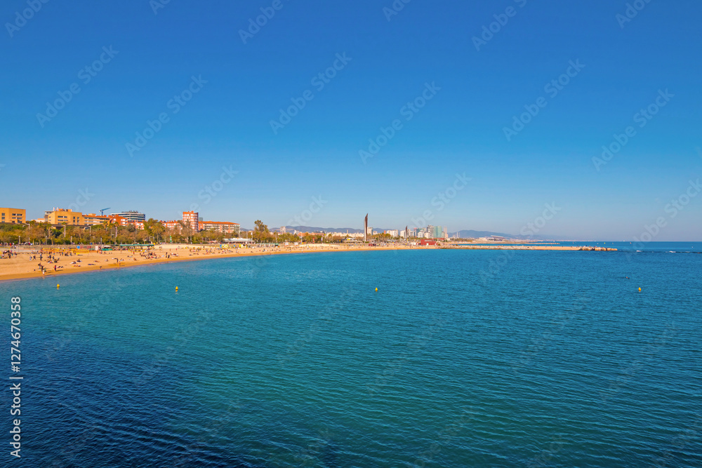 Port Olímpic Marina in Barcelona on a sunny day, featuring luxury yachts, clear blue skies, and a vibrant waterfront atmosphere along the Mediterranean coast.