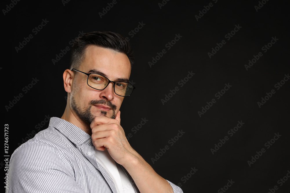 Portrait of handsome middle aged man on black background, space for text Portrait of handsome middle aged man on black background, space for text