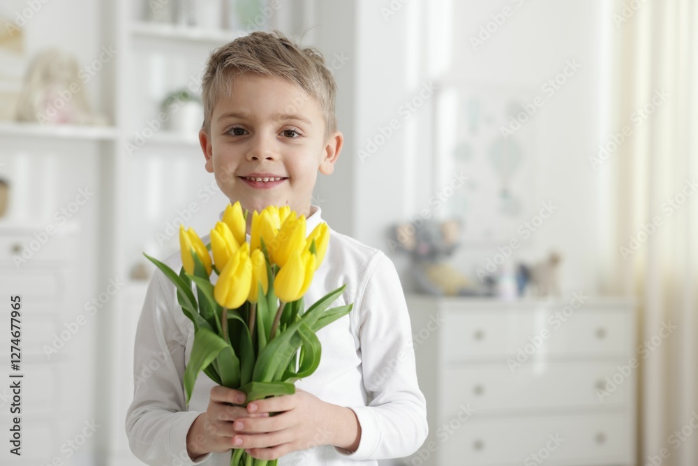 Cute little boy with bouquet of tulips at home. Space for text Cute little boy with bouquet of tulips at home. Space for text