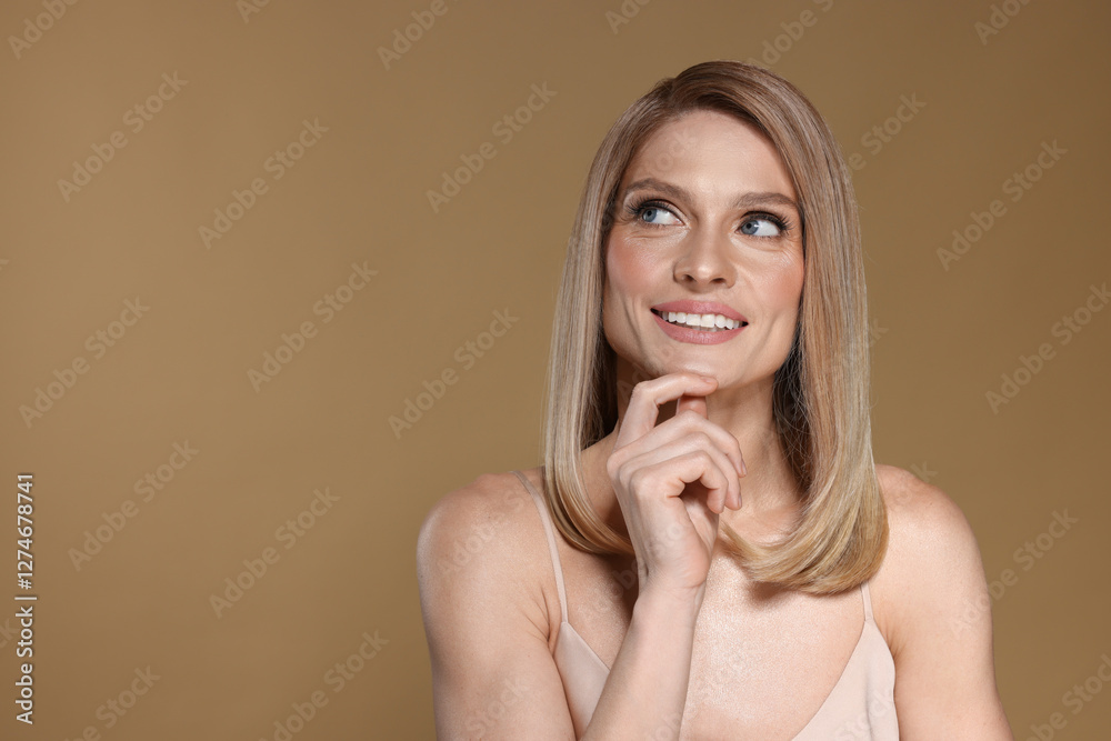 Portrait of beautiful happy woman with straight blonde hair on dark beige background, space for text Portrait of beautiful happy woman with straight blonde hair on dark beige background, space for text