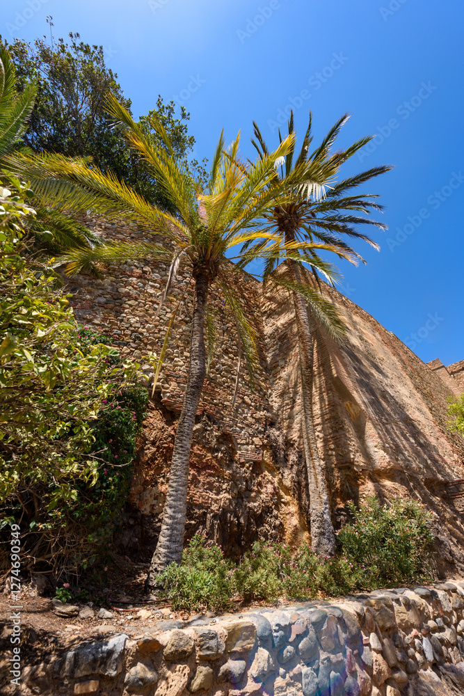Malaga, Spain - August 06, 2024: Walls and bastion of the castle fort Gibralfaro in Malaga. Castillo de Gibralfaro.